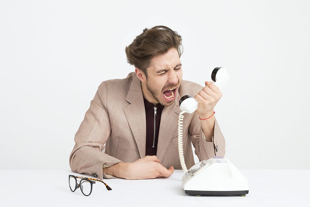 Man yells into phone