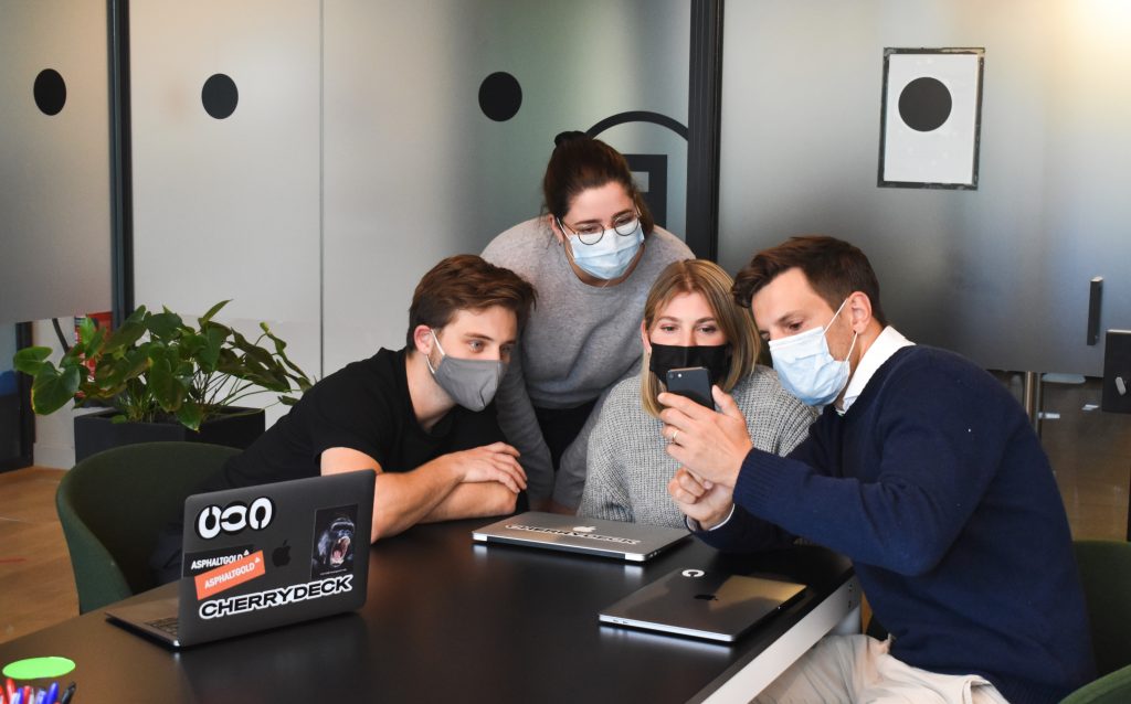 People wearing masks and discussing work